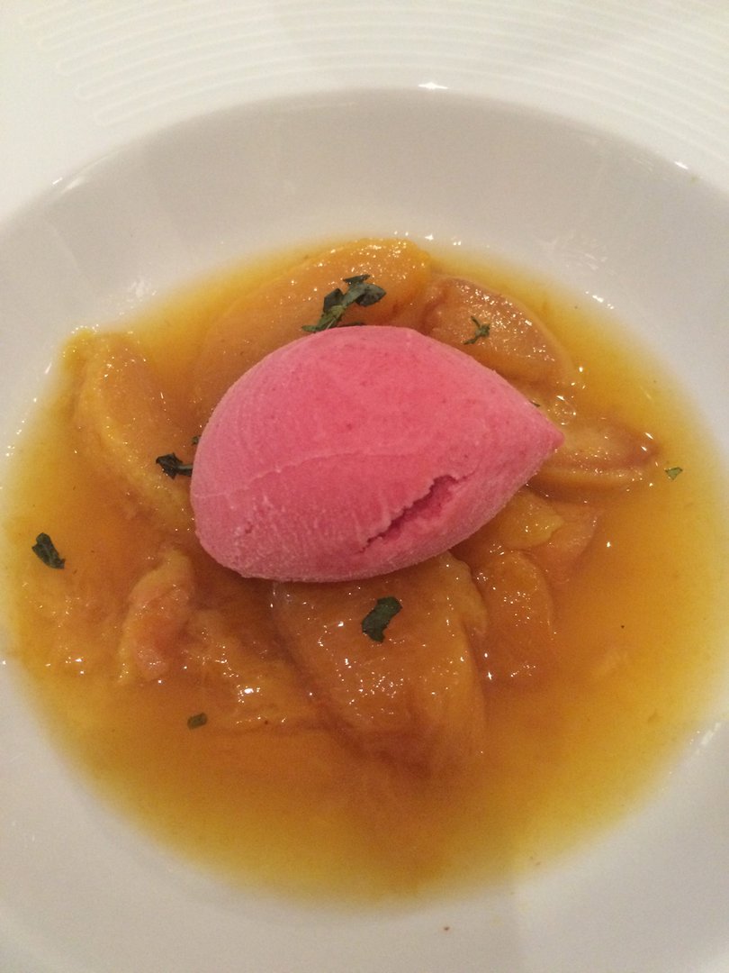 Peaches poached in saffron and basil, with raspberry sorbet