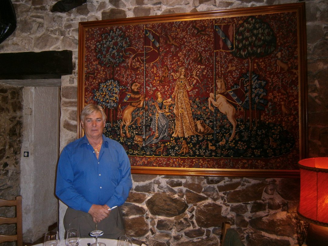 The owner in front of a tapestry he had worked himself